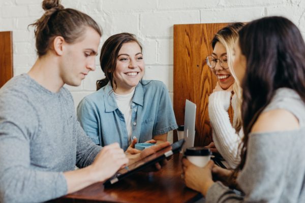 Picture of a team in a meeting in a coffee shop